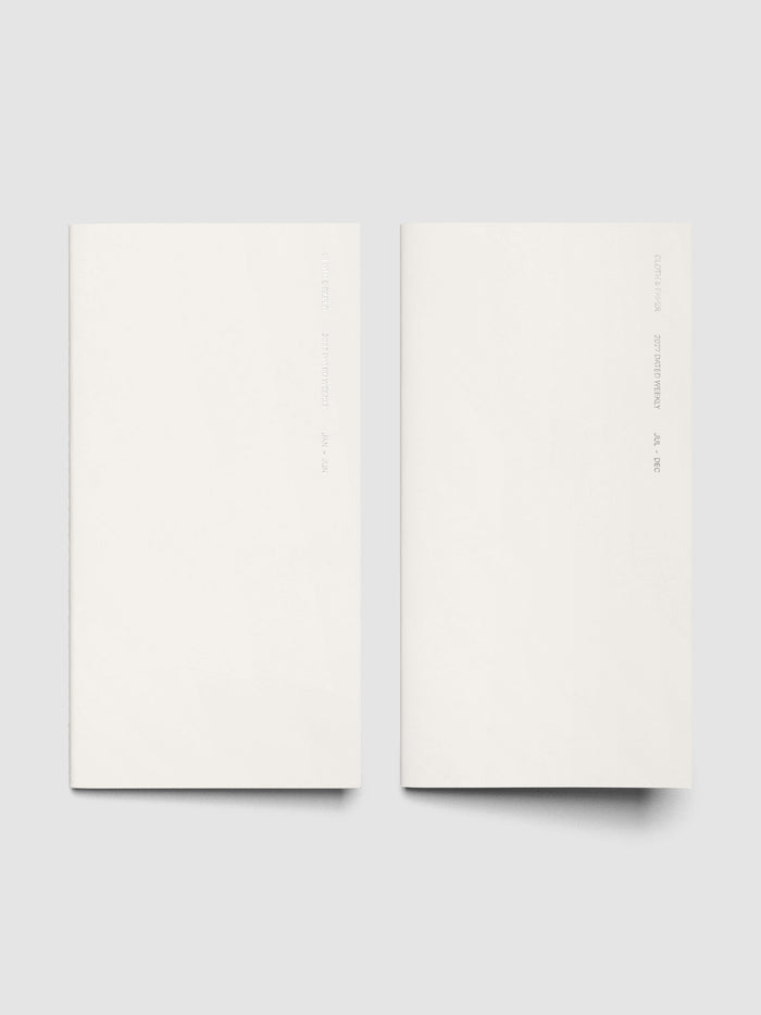 Both 2027 Dated Travel Notebooks in A5 Slim size displayed side by side, showing the off-white covers with silver foil text for the Jan–Jun and Jul–Dec volumes