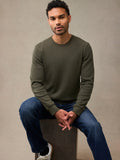 A man wearing an army green waffle flannel and blue jeans, sitting. A better thermal for a great price.