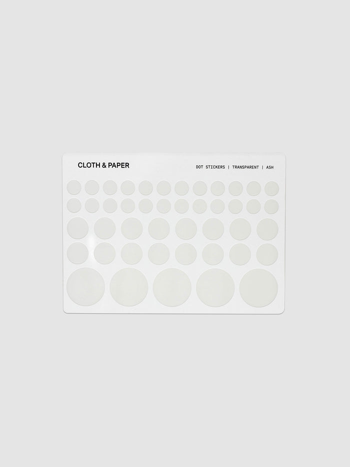 One sheet of transparent dot stickers with letters design in small, medium, and large sizes shown against a neutral background.