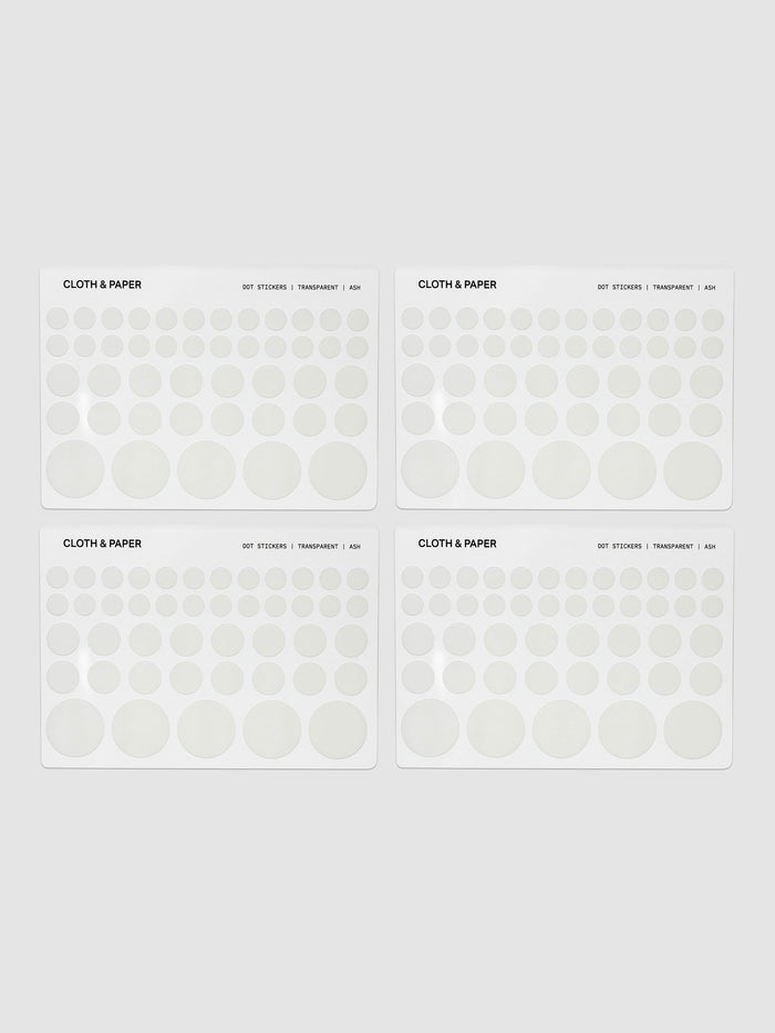 Four sheets of transparent dot stickers with letters design in small, medium, and large sizes shown against a neutral background.