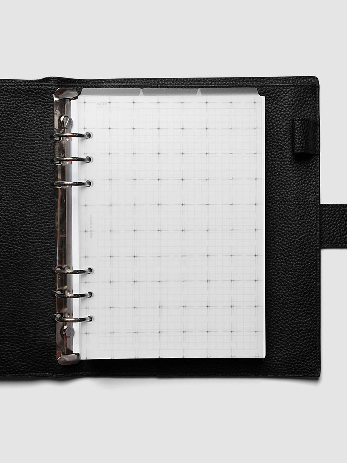 Grid Top Tab Dividers | Ultra-Thin, A5 6-Ring Punch, dividers loaded in a black pebbled leather ring bound planner with silver rings, three staggered tabs across the top and a white grid notes insert underneath