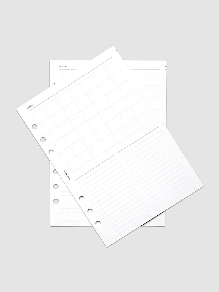 Monthly Fold Out Planner Insert Set of 2, A5 6-Ring Punch, both white inserts of the set overlapping at an angle on a pale gray surface, gray monthly grid and lined note columns visible on the top sheet