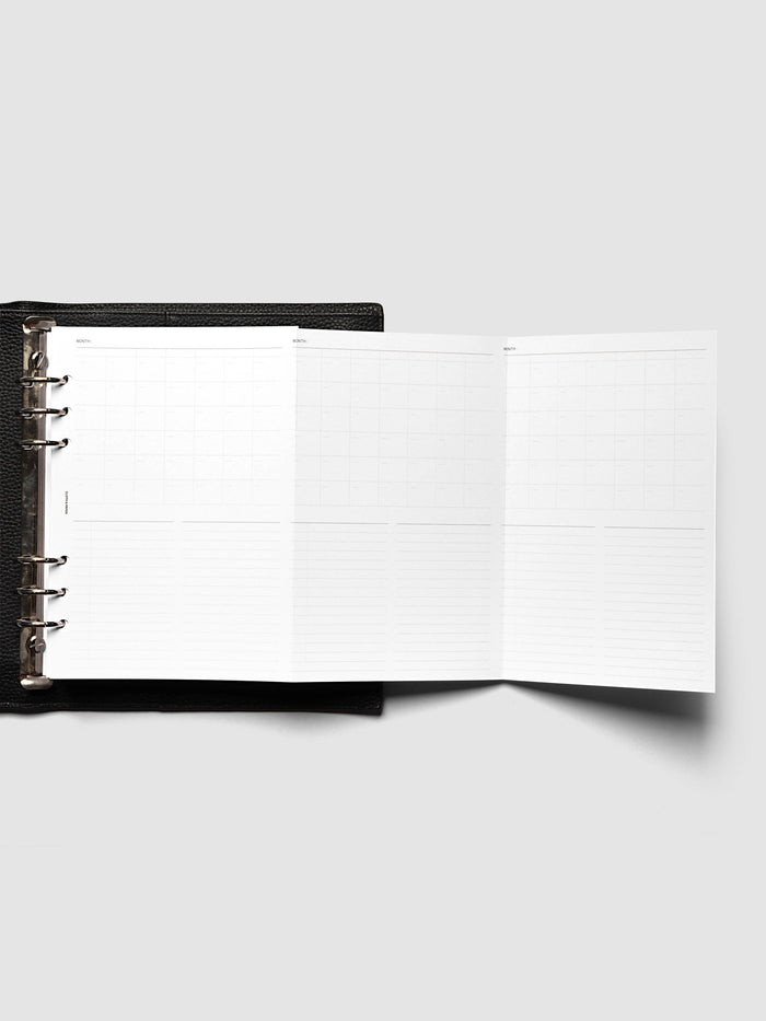 Monthly Fold Out Planner Insert Set of 2, A5 6-Ring Punch, the insert unfolded to the right of a black leather ring bound planner with silver rings, extending three monthly panels past the cover
