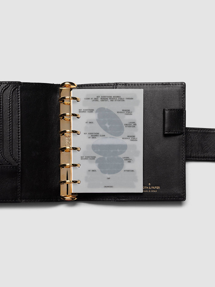 Nuanced Dashboard Trio, Pocket 6-Ring Punch, dashboard on the gold rings of a black leather planner with the gold Cloth & Paper stamp at the lower right