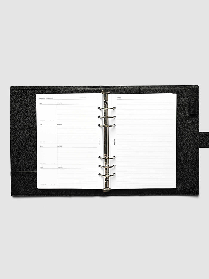 The A5 6-Ring Punch Personal Curriculum Planner Inserts open in a black leather ring bound planner to the index spread, four skill entries with purpose and due date on the left and a lined notes page on the right