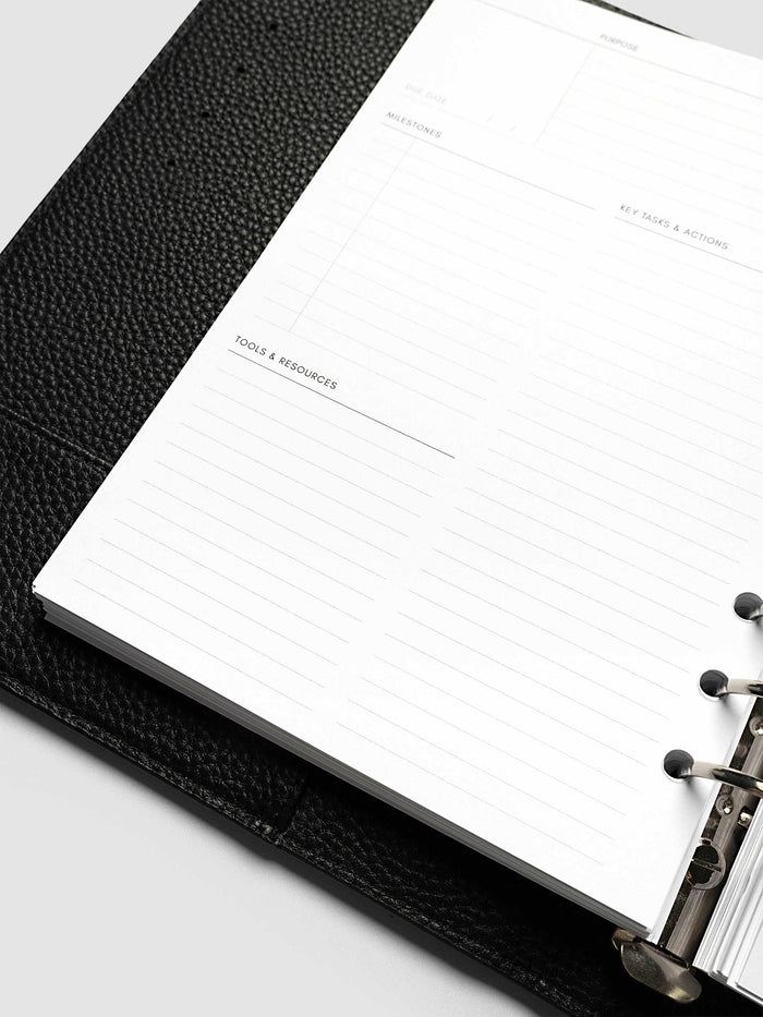 Close-up at an angle of the lower left page of a skill spread in the A5 6-Ring Punch Personal Curriculum Planner Inserts, showing the milestones, key tasks and tools and resources sections