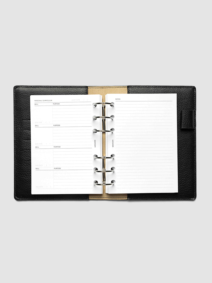 The A6 Personal Curriculum Planner Inserts open in a black leather ring bound planner to the index spread, four skill entries with purpose and due date on the left and a lined notes page on the right