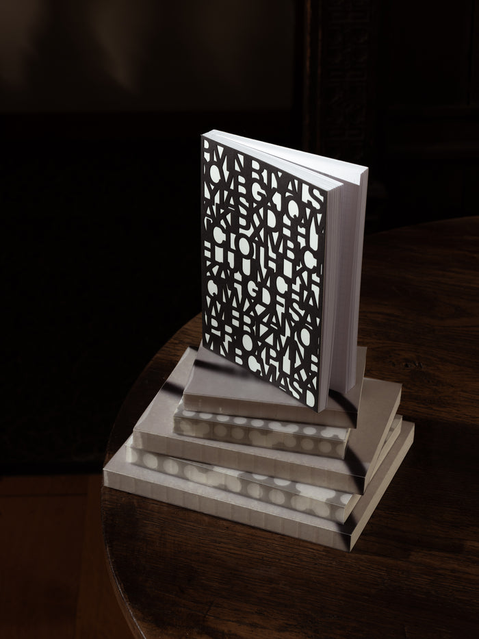 The Precision Notebook | A5 closed, showing the cover cut all the way through in the Precision letter pattern over a light layer beneath