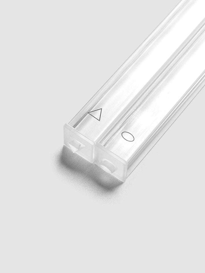 Close up of the Stamp Sticks | Set of 2 angled toward the stamping ends, clear sticks marked with a black triangle outline on one stick and a black oval outline on the other