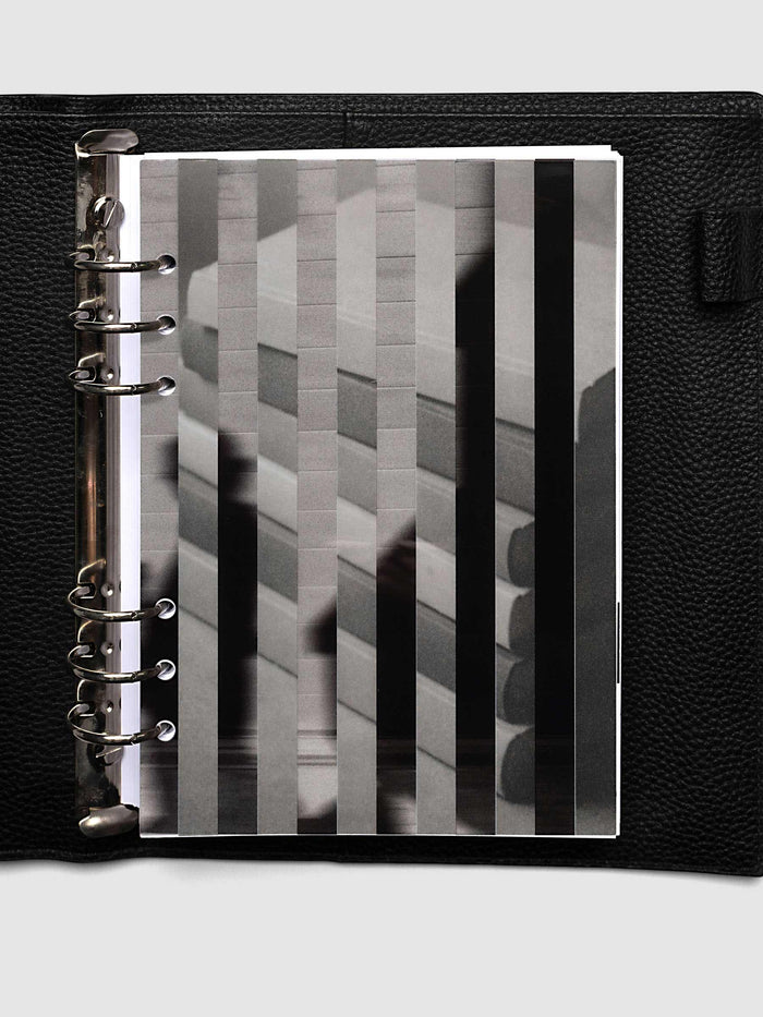 The A5 6-Ring Punch Strips Planner Dashboard Duo layered at the front of a black leather ring bound planner, both images combining into one striped picture