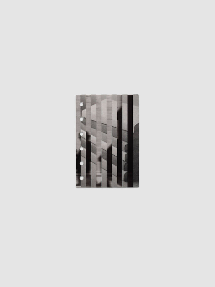 The vellum base layer of the Pocket Strips Planner Dashboard Duo laid flat, showing a greyscale photograph of a stack of books sliced into vertical strips and offset