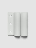 System Punch Pen Holder | Aspen, ring punch, pale gray holder shown flat with three round holes punched along the left edge on a light gray background
