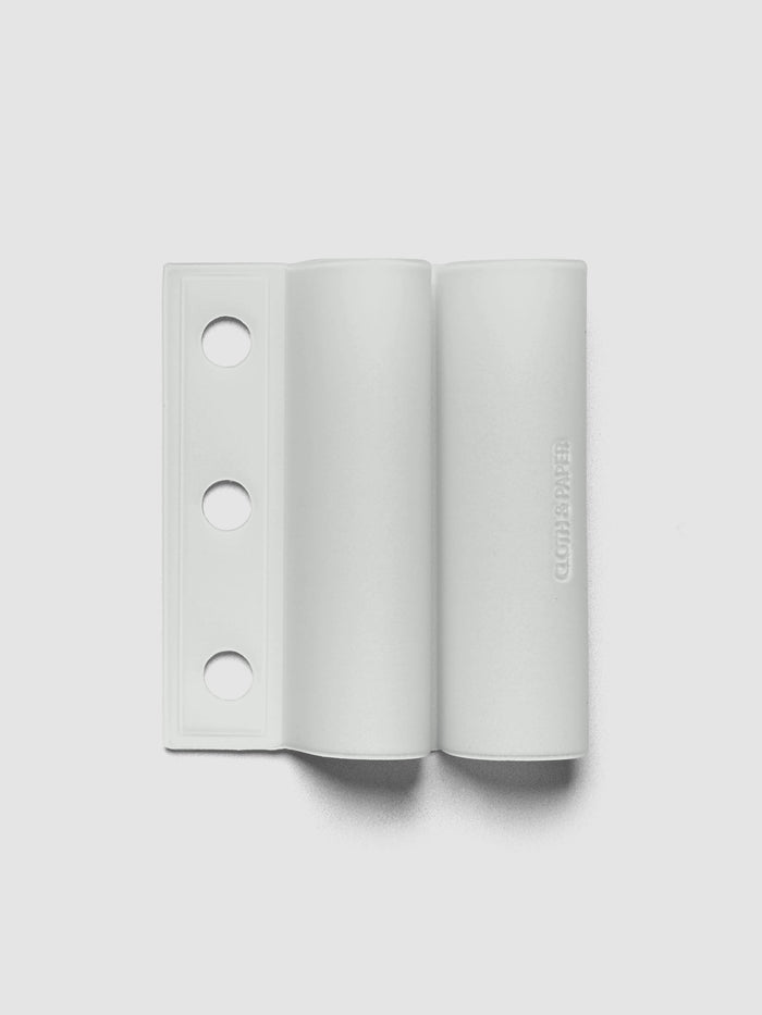 System Punch Pen Holder | Aspen, ring punch, pale gray holder shown flat with three round holes punched along the left edge on a light gray background